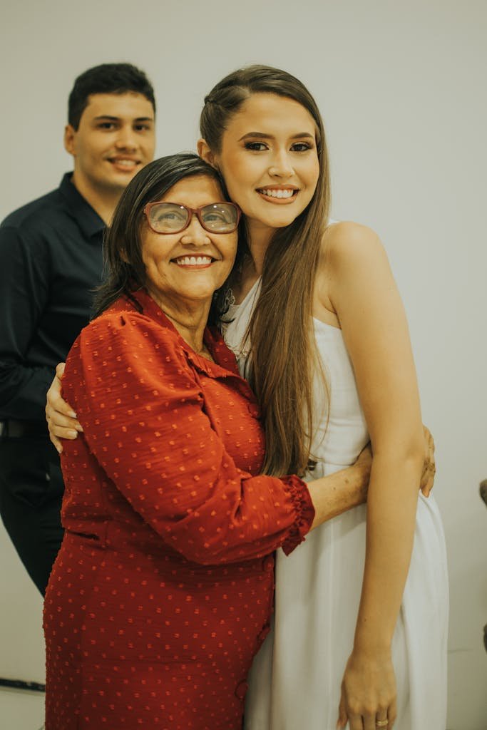A joyful moment captured among a multigenerational family with warm smiles and embraces.