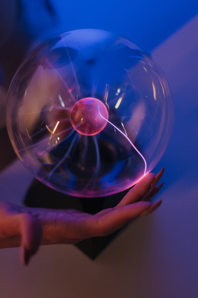 A mesmerizing plasma ball generating colorful electric arcs in a dark room, creating a scientific and futuristic vibe.